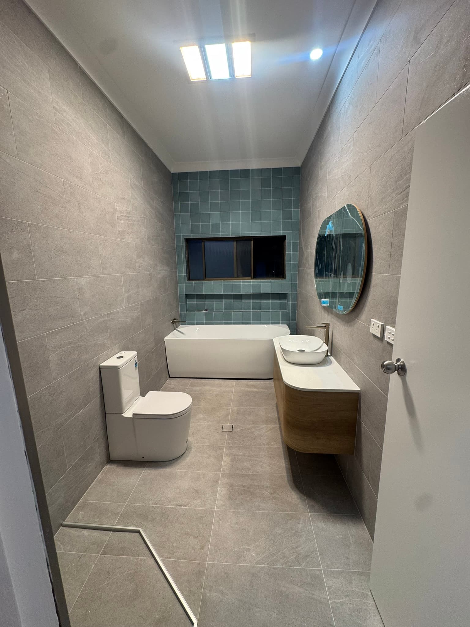 Finished bathroom with vanity, bath and toilet